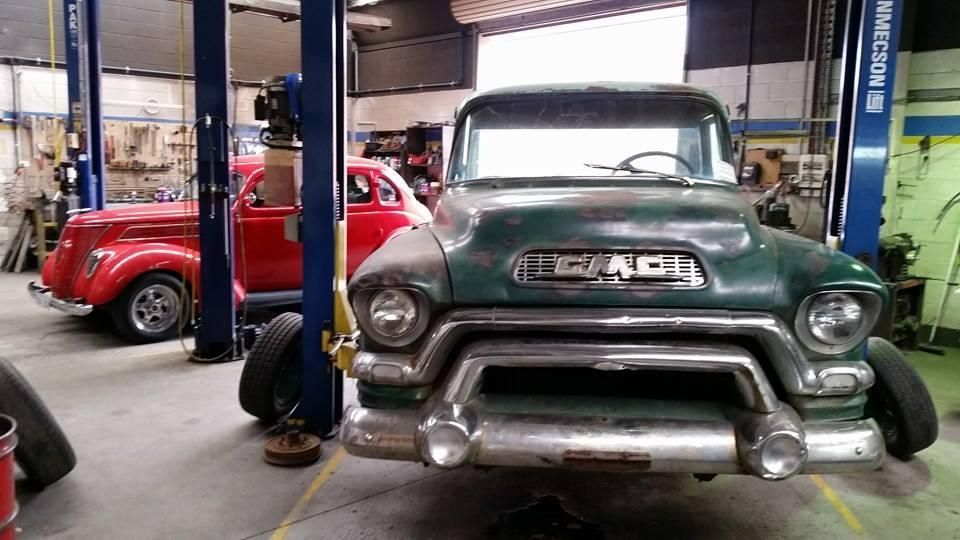 A Green Gmc Truck is Sitting on a Lift in a Garage — Wodonga Brake & Clutch In Wodonga, VIC