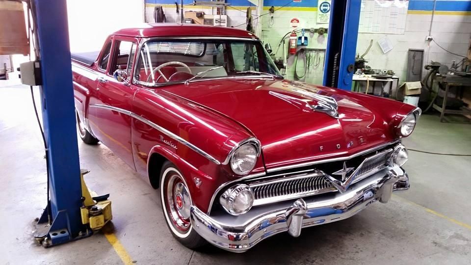 A Red Ford Car is on a Lift in a Garage — Wodonga Brake & Clutch In Wodonga, VIC