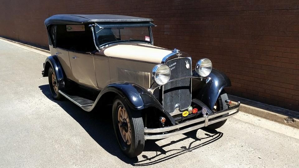 An Old Car is Parked on the Side of the Road in Front of a Brick Wall — Wodonga Brake & Clutch In Wodonga, VIC