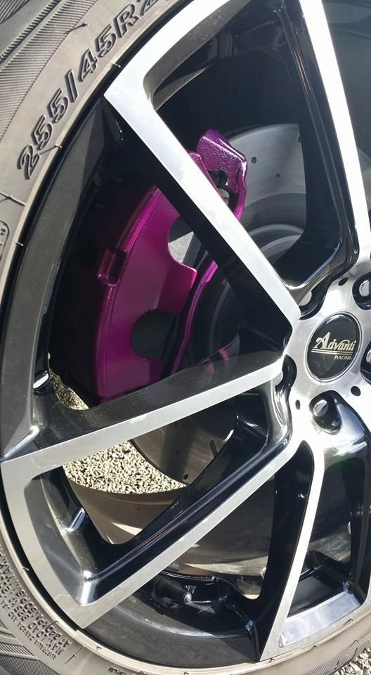 A Close Up of a Purple Brake Caliper on a Car Wheel — Wodonga Brake & Clutch In Wodonga, VIC