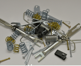 A Pile of Metal Springs and Screws on a White Surface — Wodonga Brake & Clutch In Wodonga, VIC