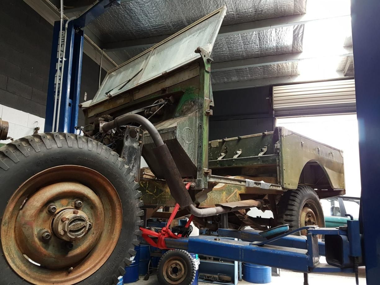 A Military Vehicle is Sitting on a Lift in a Garage — Wodonga Brake & Clutch In Wodonga, VIC