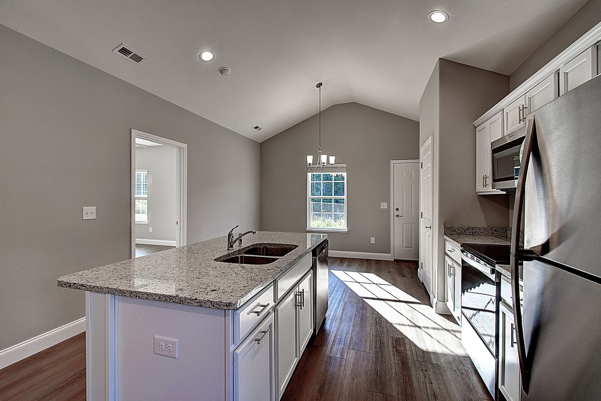 A kitchen with granite counter tops and stainless steel appliances