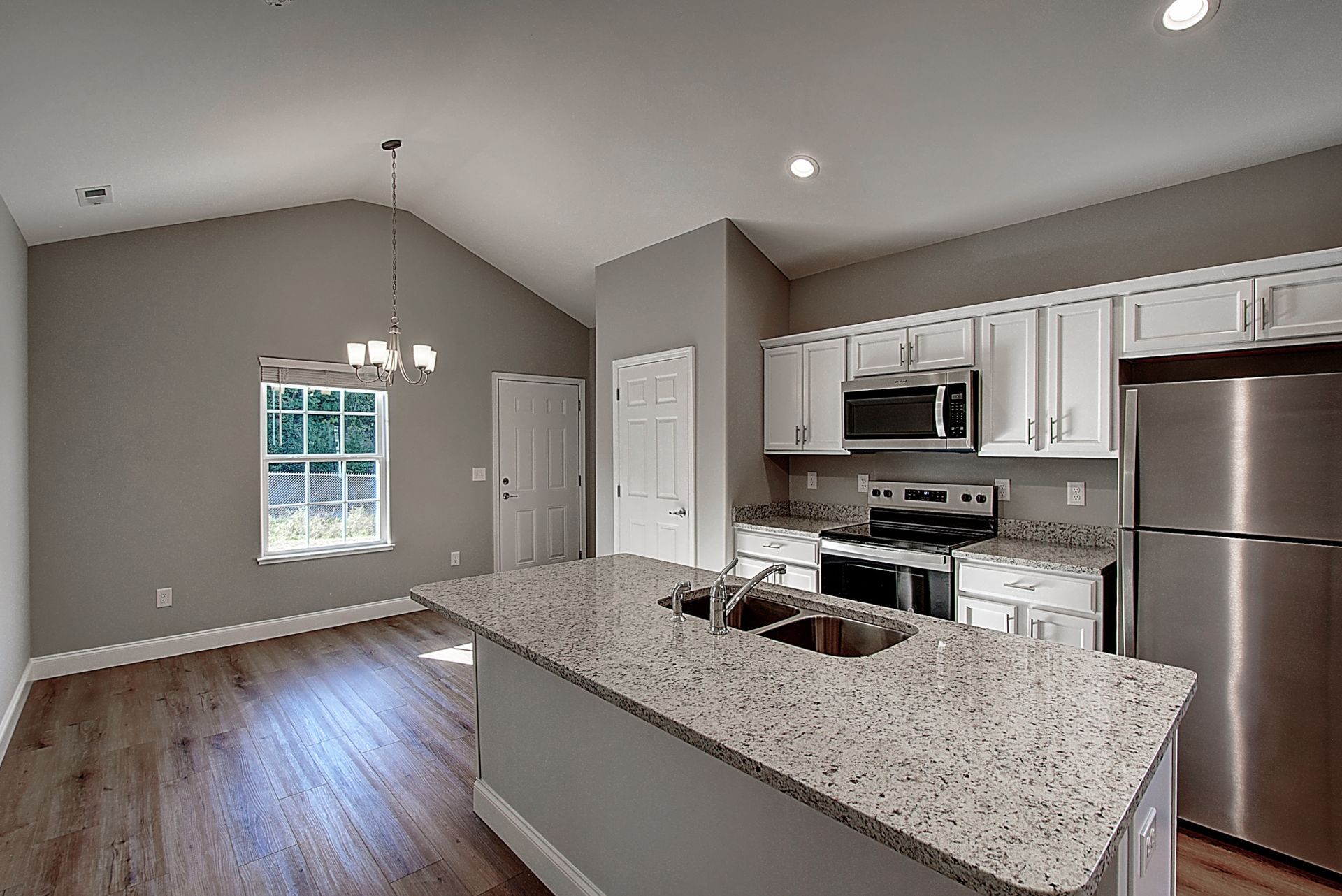 A kitchen with granite counter tops and stainless steel appliances