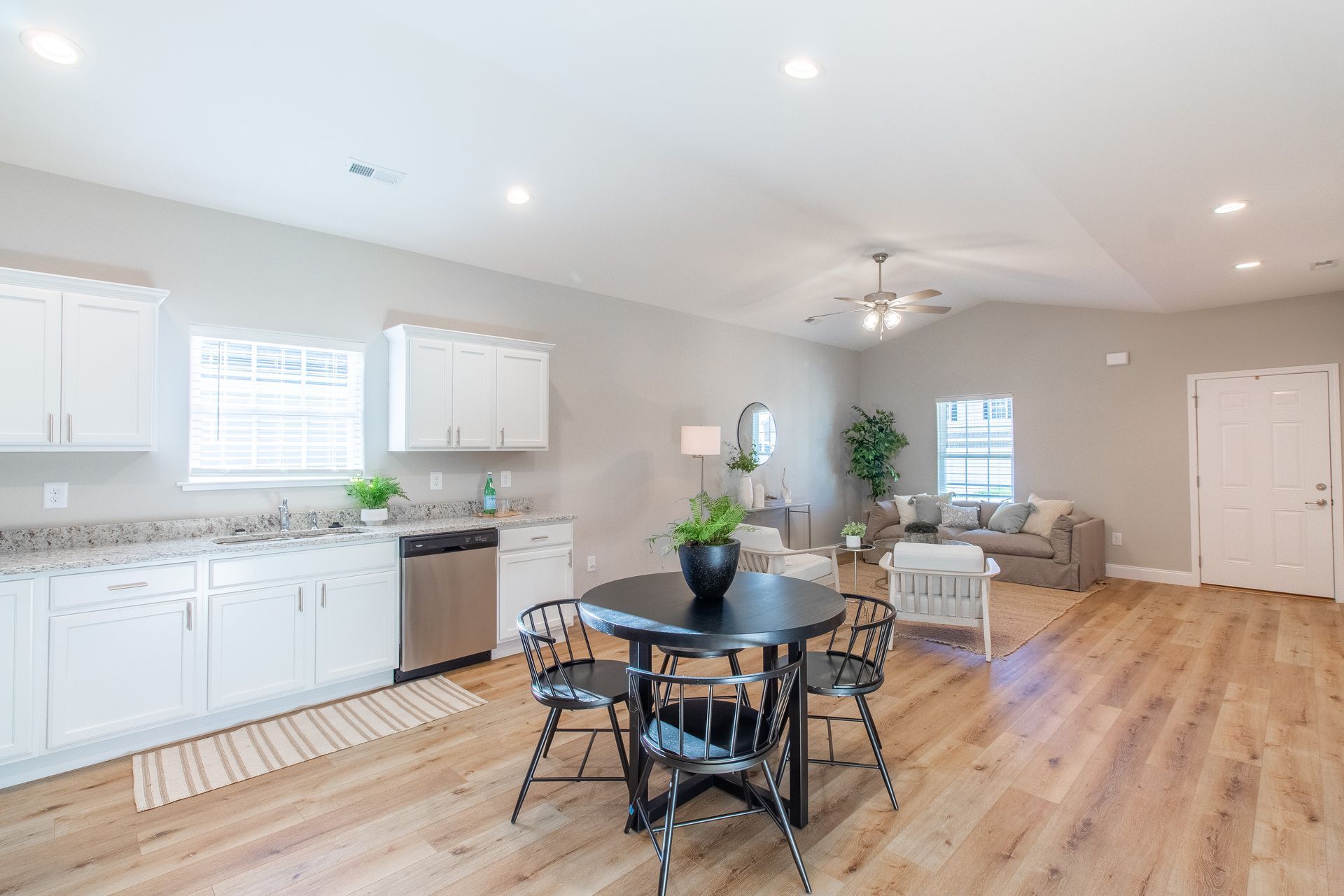 There is a table and chairs in the middle of the room.