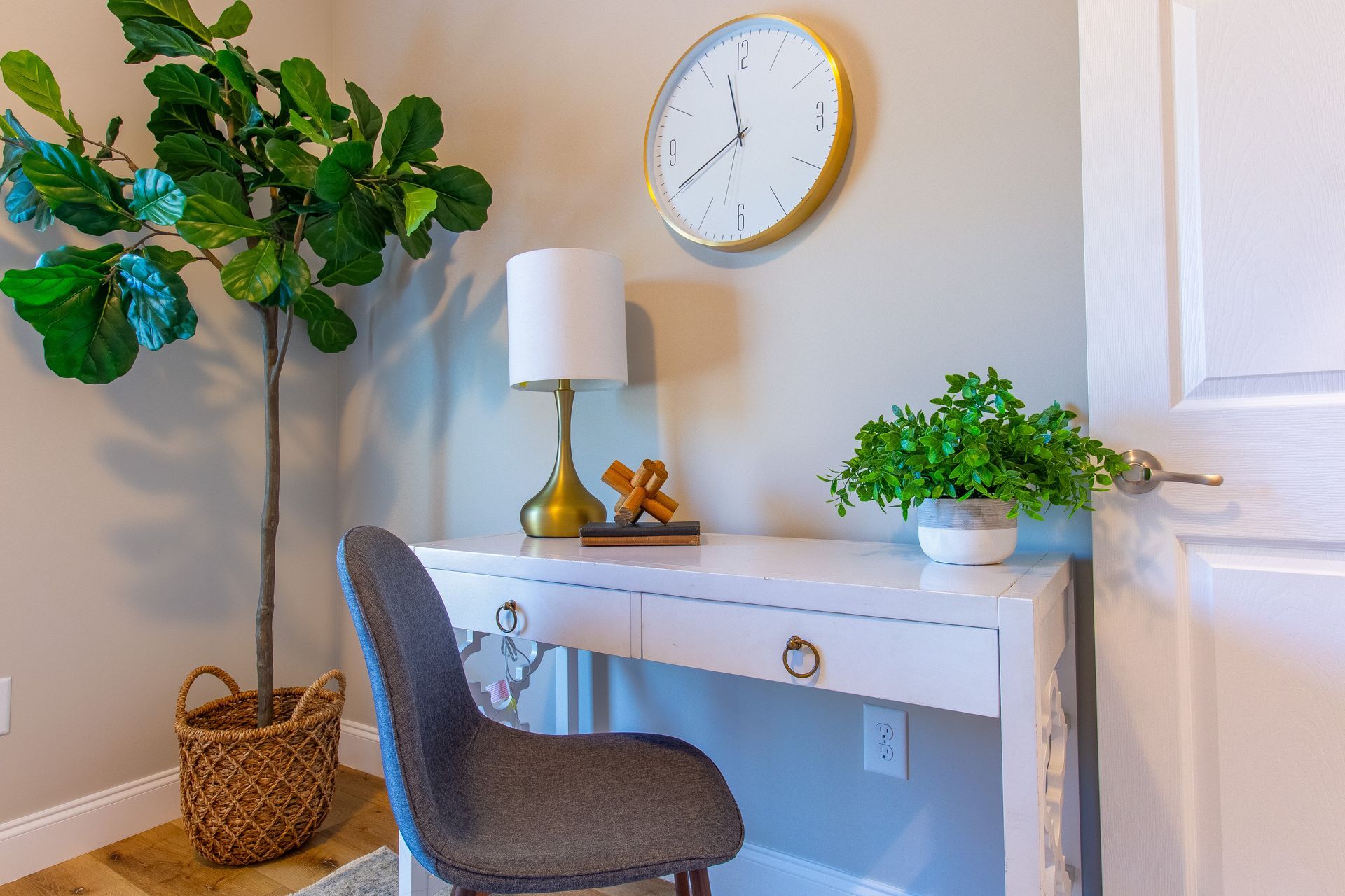 There is a clock on the wall above the desk.