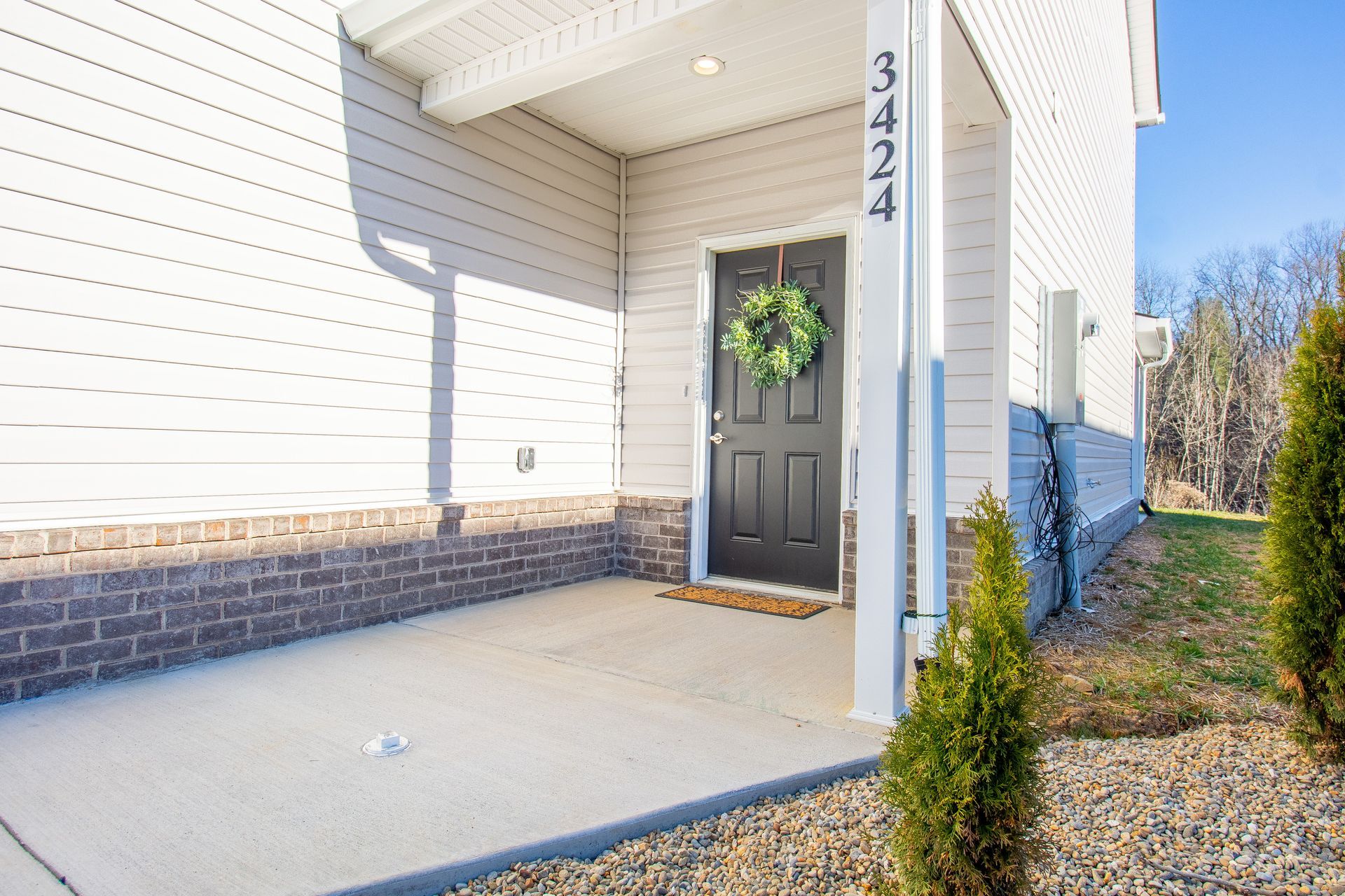The front door of a house with a wreath on it.