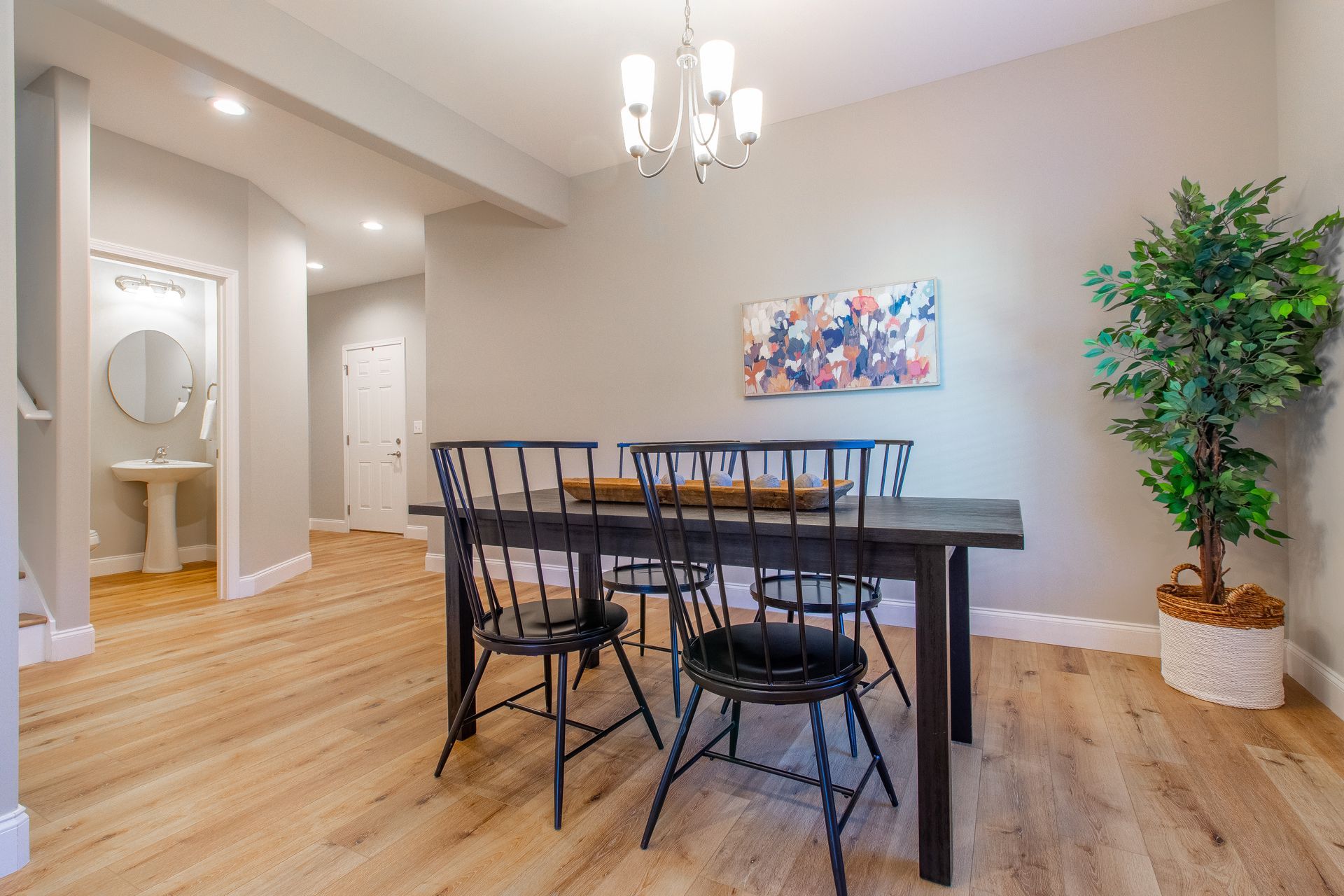 A dining room with a table and chairs and a chandelier.