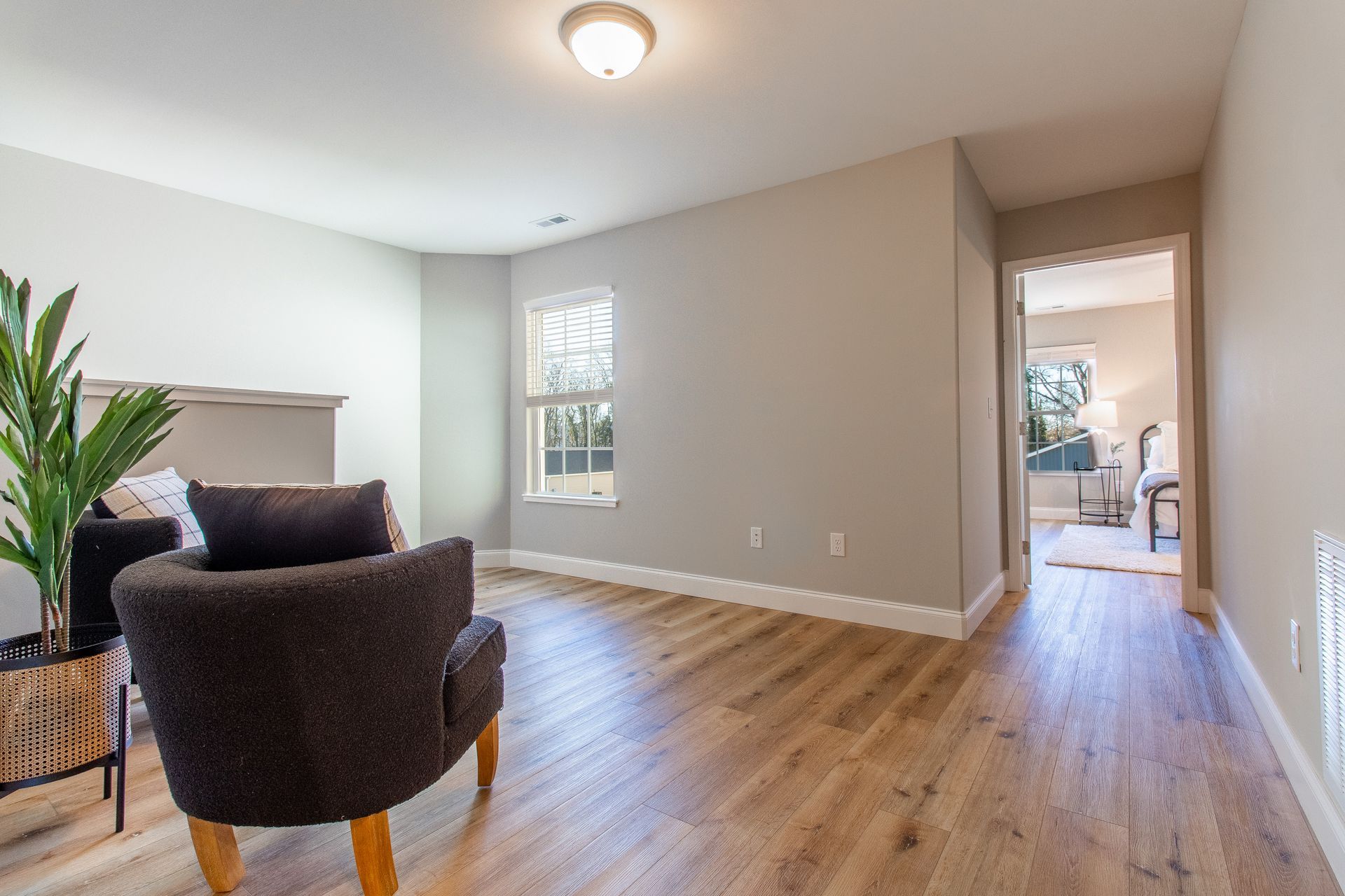 A living room with hardwood floors and a chair.
