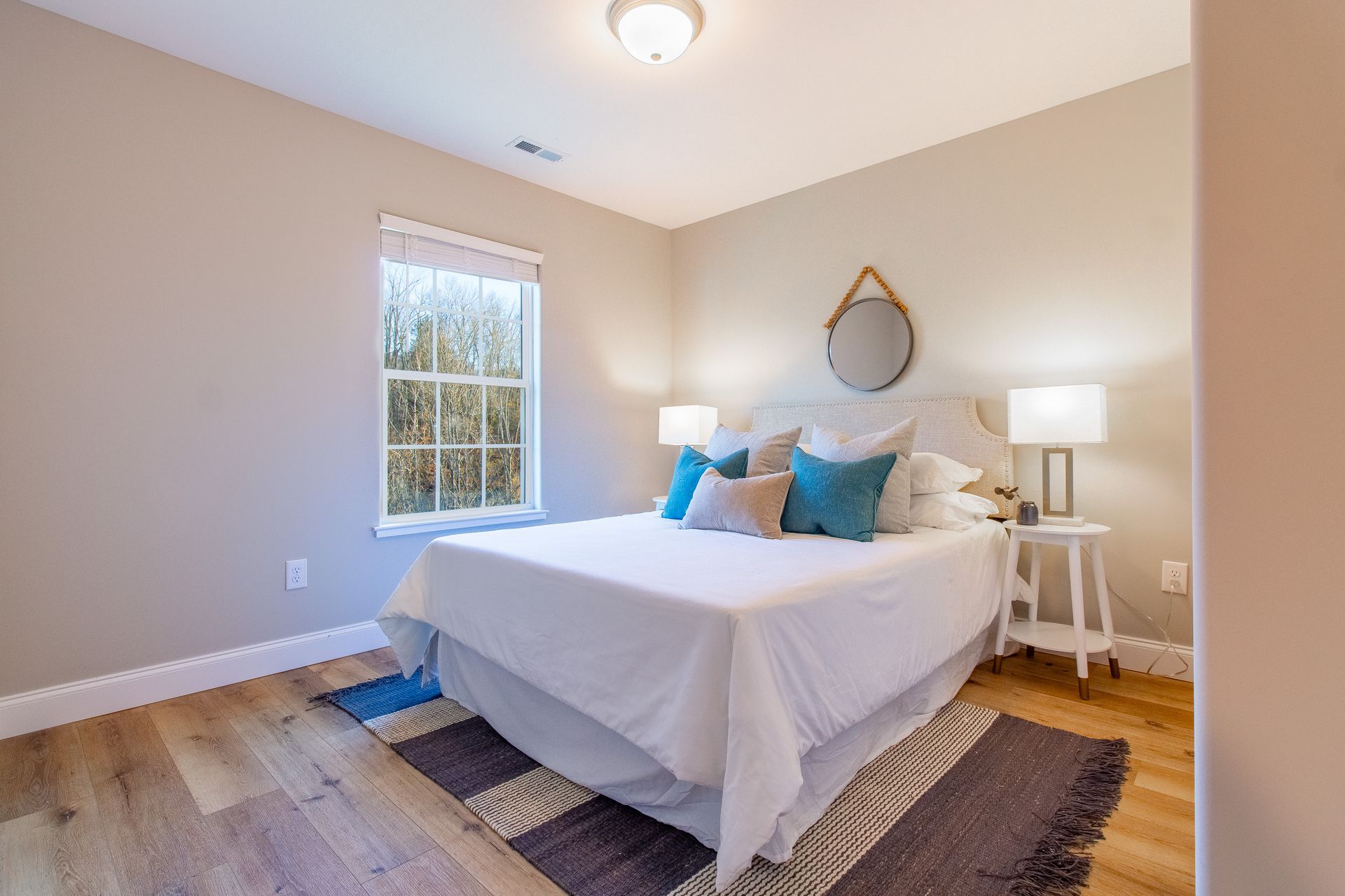 A bedroom with a large bed and a window.