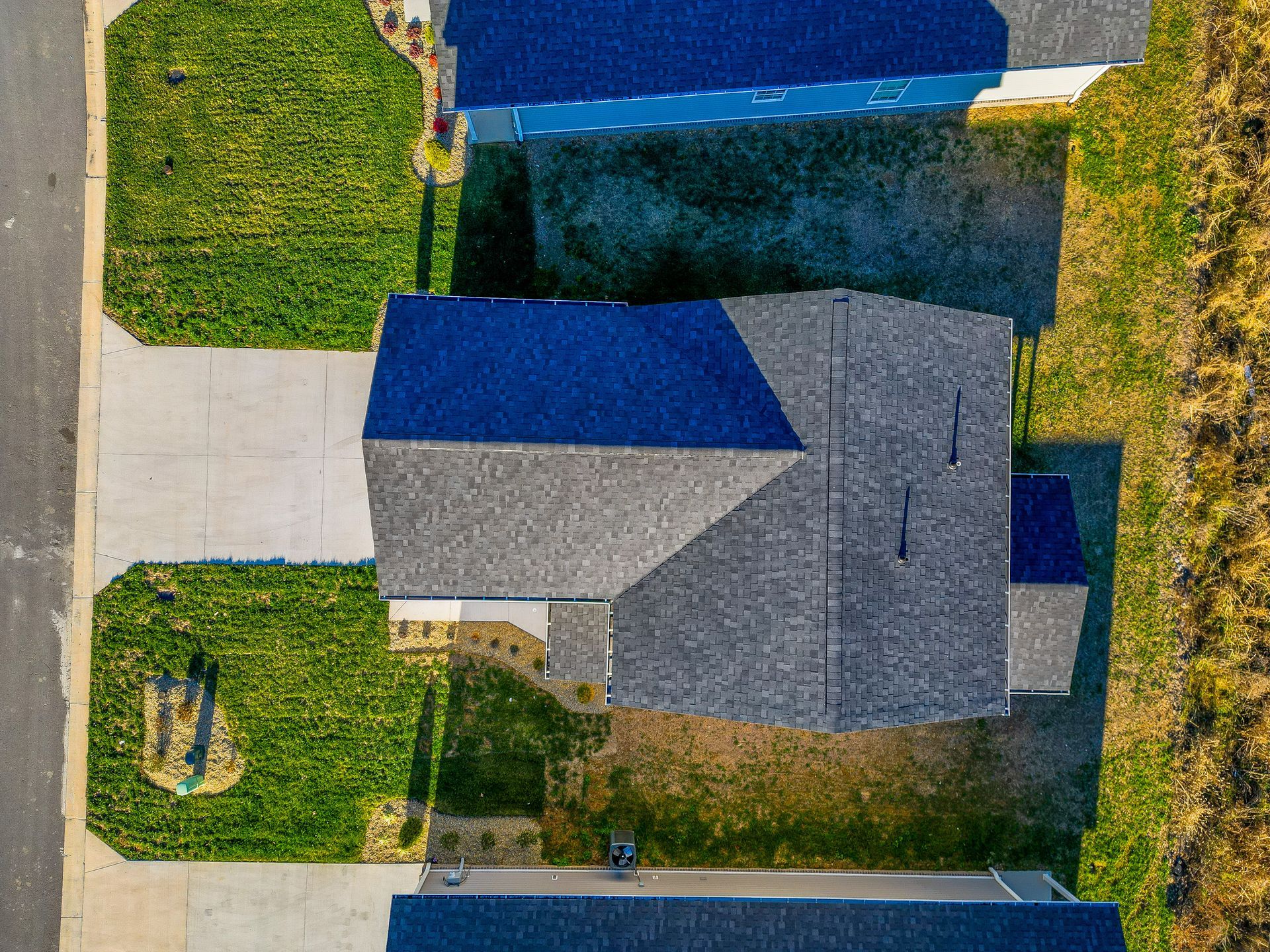 An aerial view of a house with a blue roof