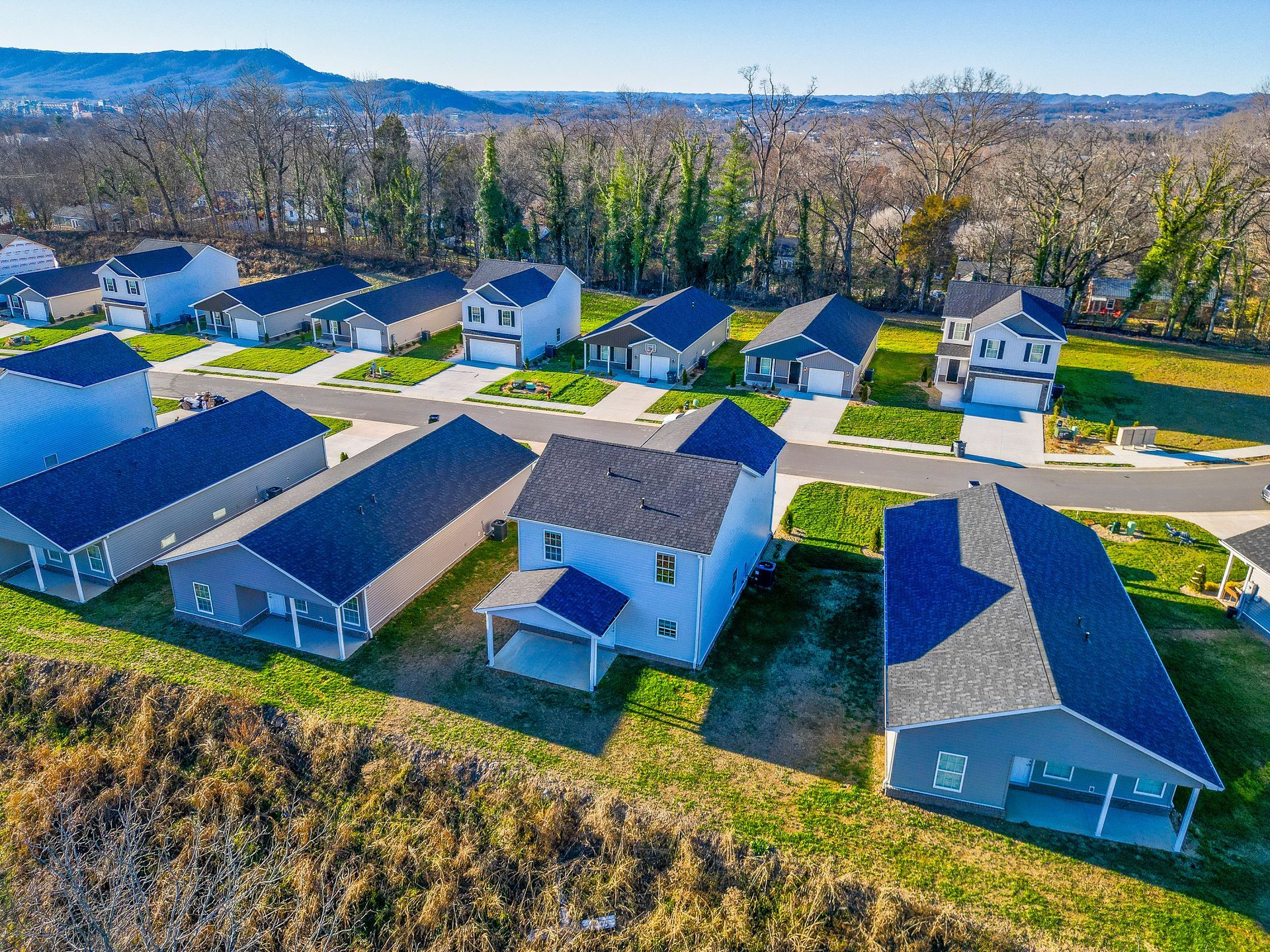 An aerial view of a residential neighborhood with lots of houses and trees.