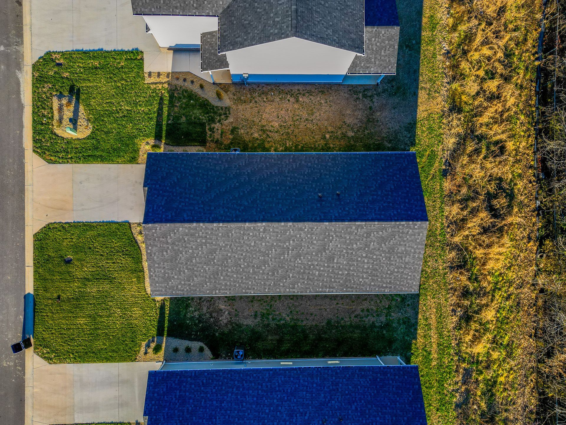 An aerial view of a row of houses with blue roofs.
