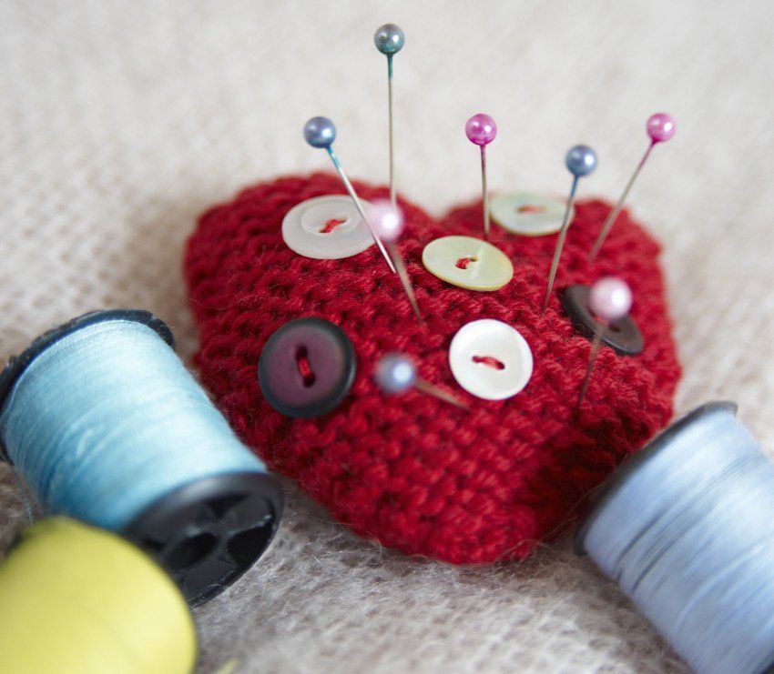 Heart-shaped pin cushion. buttons and thread