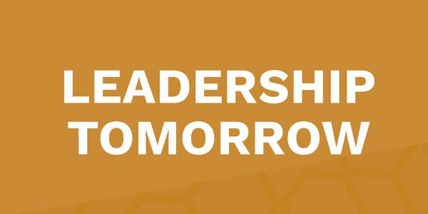 A yellow background with the words `` leadership tomorrow '' written on it.