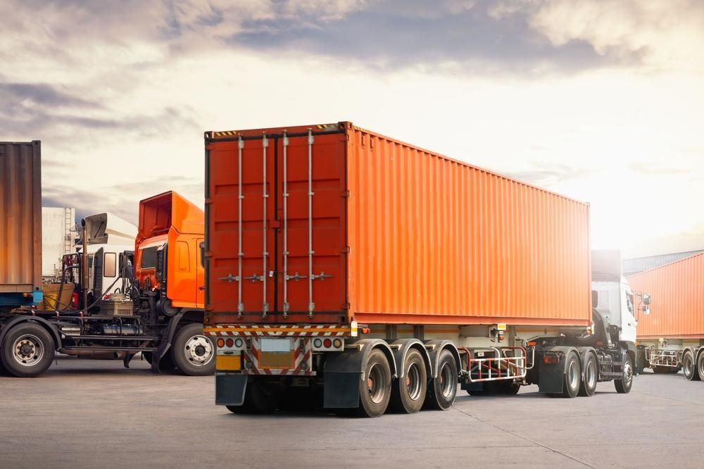 A Row Of Semi Trucks Are Parked Next To Each Other In A Parking Lot — Brisbane Moving & Storage In Acacia Ridge, QLD