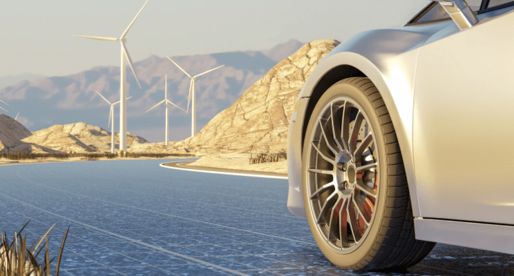 Car on solar road with windmills in background