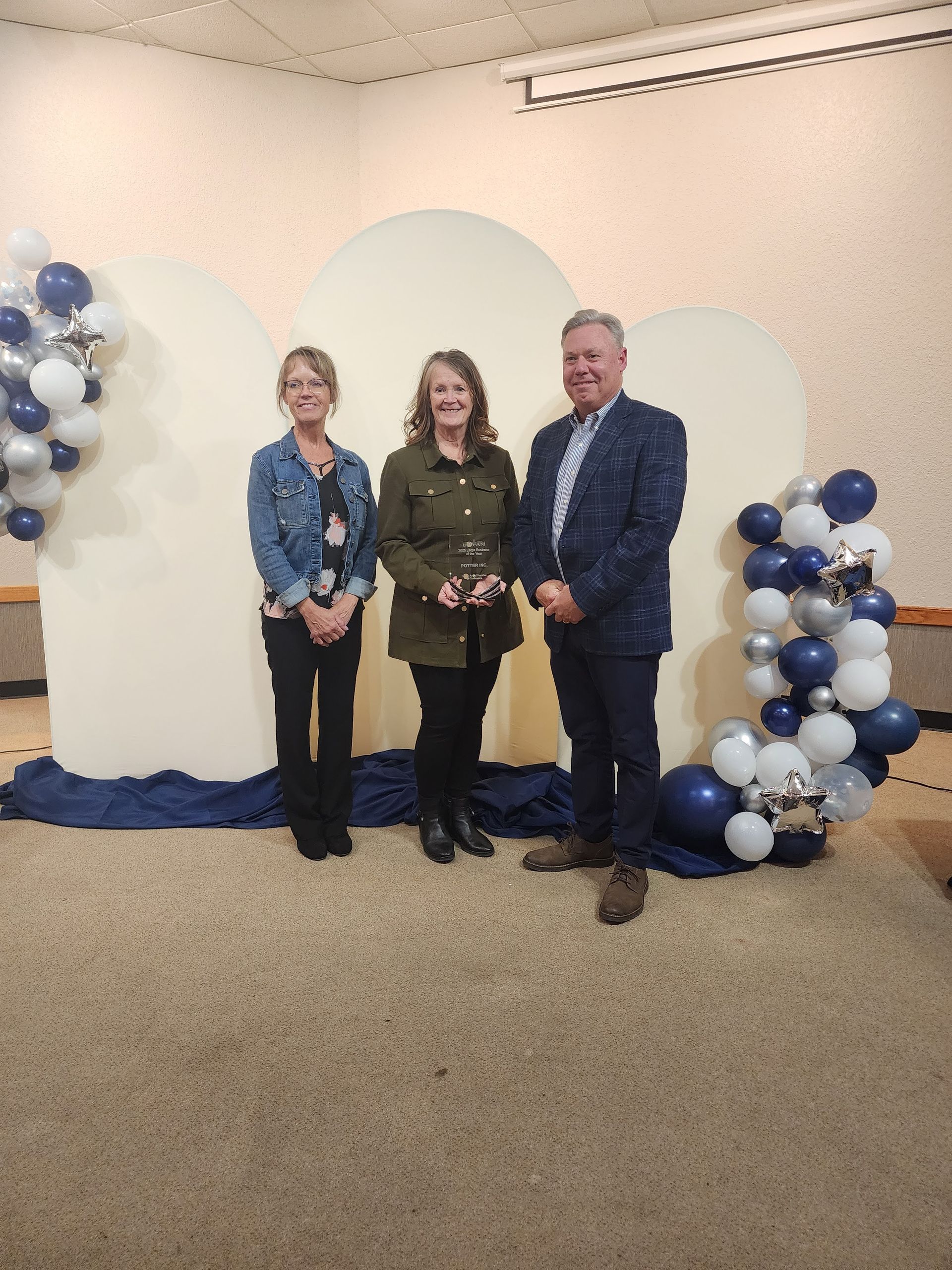 Potter Inc. standing with the award for Large Business of the Year