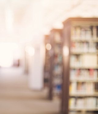 A blurred image of a street with buildings.
