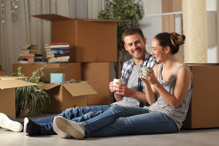 couple laughing with moving boxes