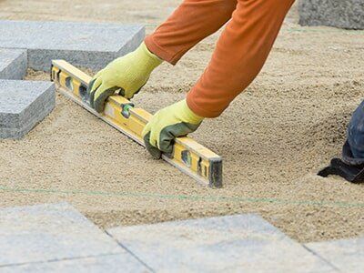 Worker Laying Sand For Landscaping Job — Landscaping Supplies in Mudgee, NSW