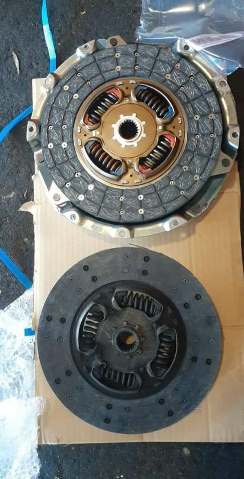Two Clutch Discs Are Sitting on Top of Each Other on a Cardboard Box — CB Automotive In Yatala, QLD