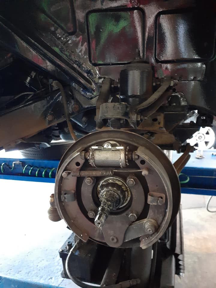 A Close Up of a Car 's Brake System on a Lift — CB Automotive In Yatala, QLD