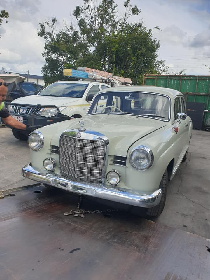 A White Mercedes Benz is Parked in a Parking Lot Next to a White Truck — CB Automotive In Yatala, QLD