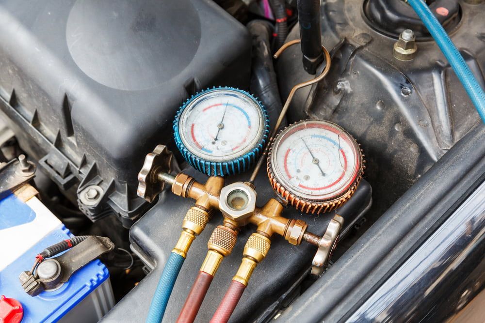 Two gauges are sitting under the hood of a car. — CB Automotive In Yatala, QLD