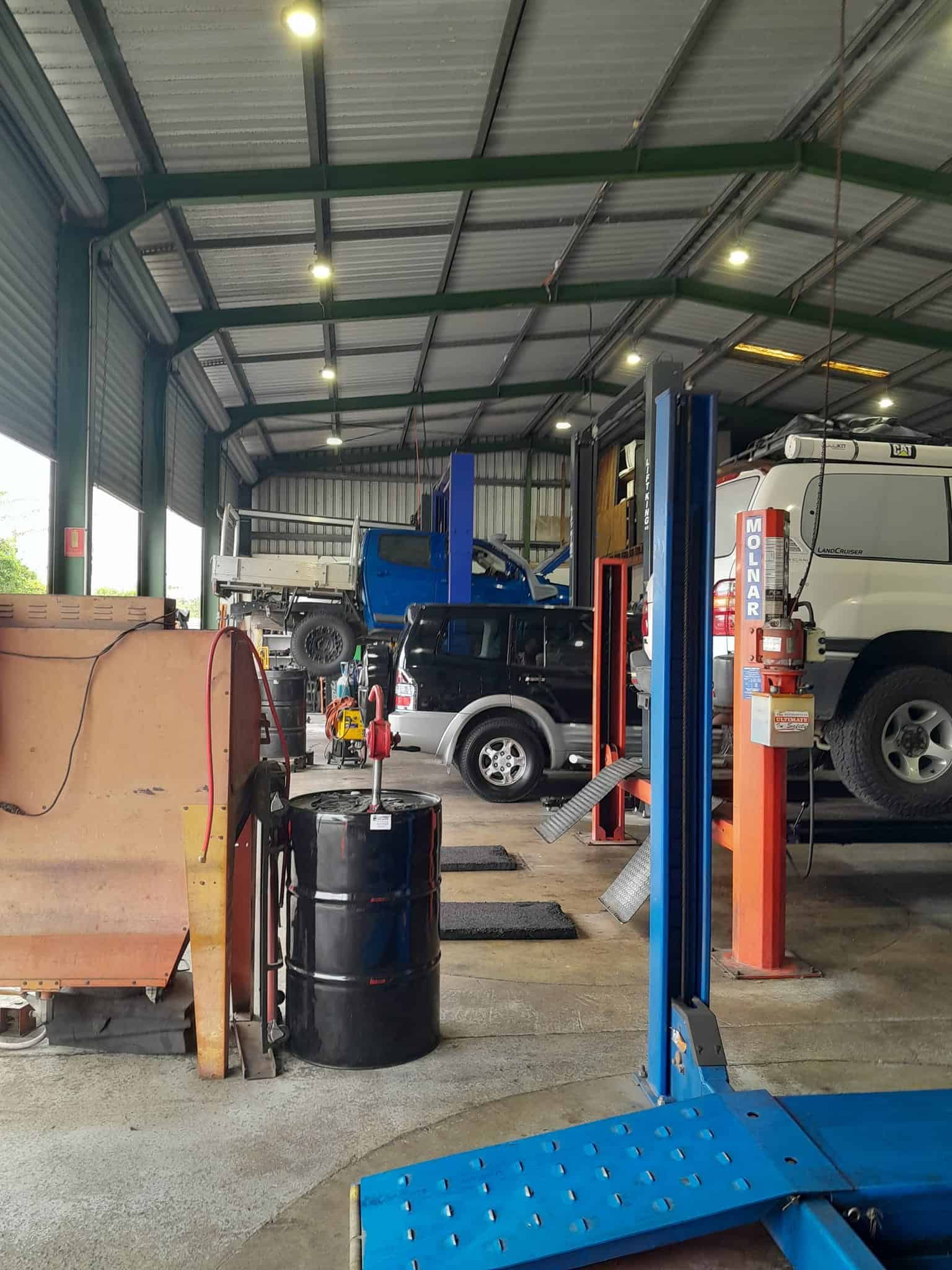 A Garage With a Lot of Vehicles Parked Inside of It — CB Automotive In Yatala, QLD