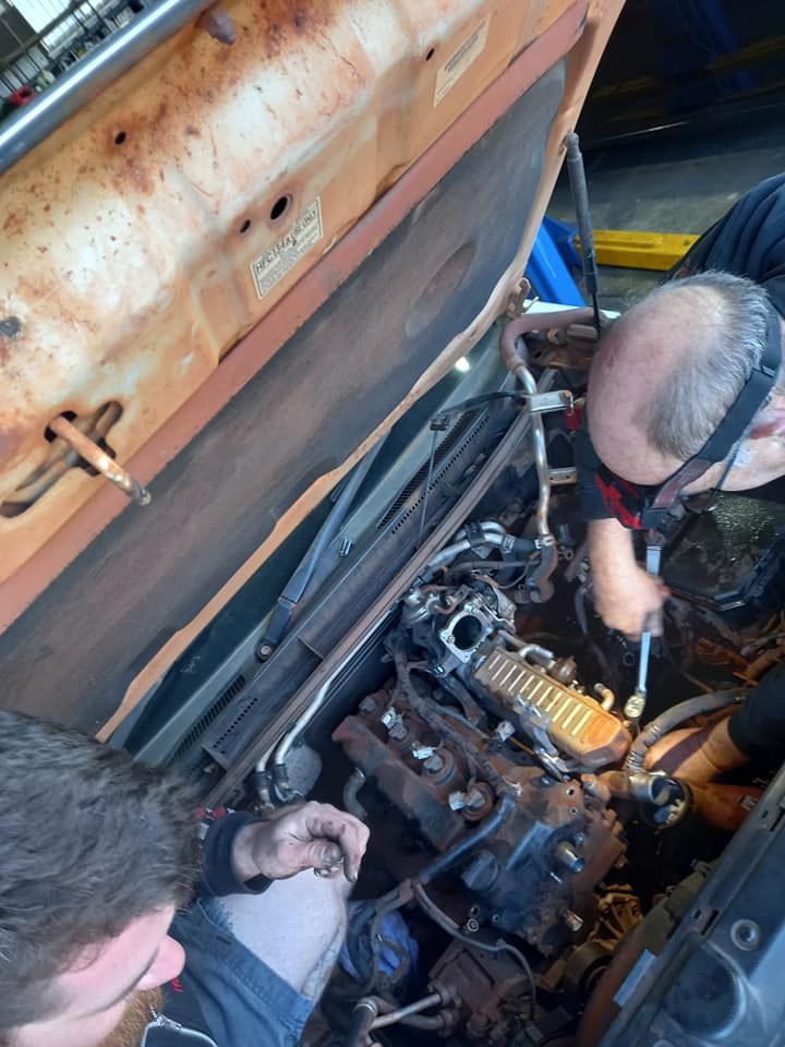 Two Men Are Working on a Car Engine With the Hood Open — CB Automotive In Yatala, QLD