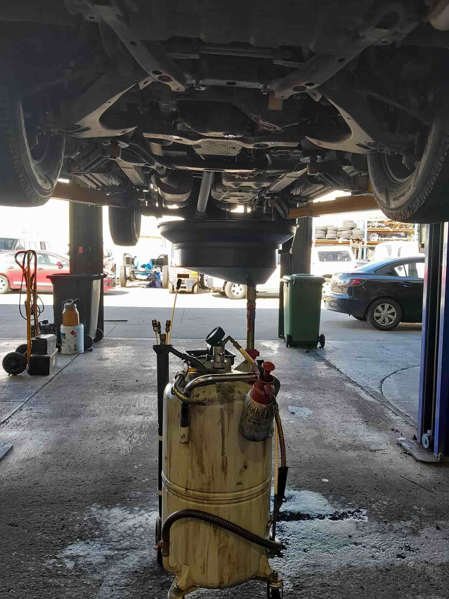 The Underside of a Car is Being Worked on in a Garage — CB Automotive In Yatala, QLD