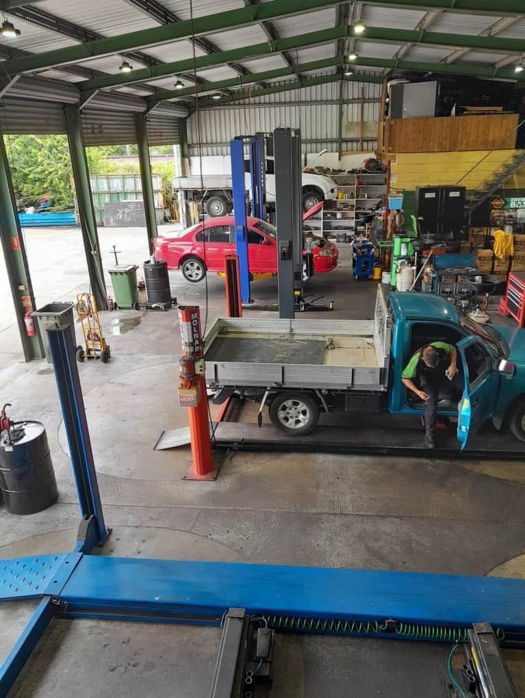 A Man is Working on a Truck in a Garage — CB Automotive In Yatala, QLD