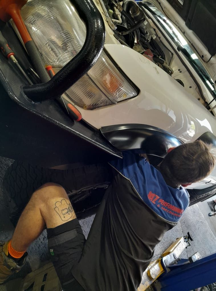 A Man is Working on a Car in a Garage — CB Automotive In Yatala, QLD