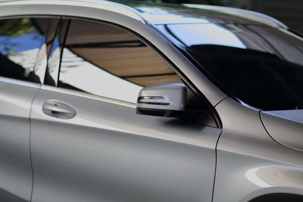 A Silver Car is Parked in a Parking Lot With the Door Open — Keppel Coast Windscreens in Coorooman, QLD