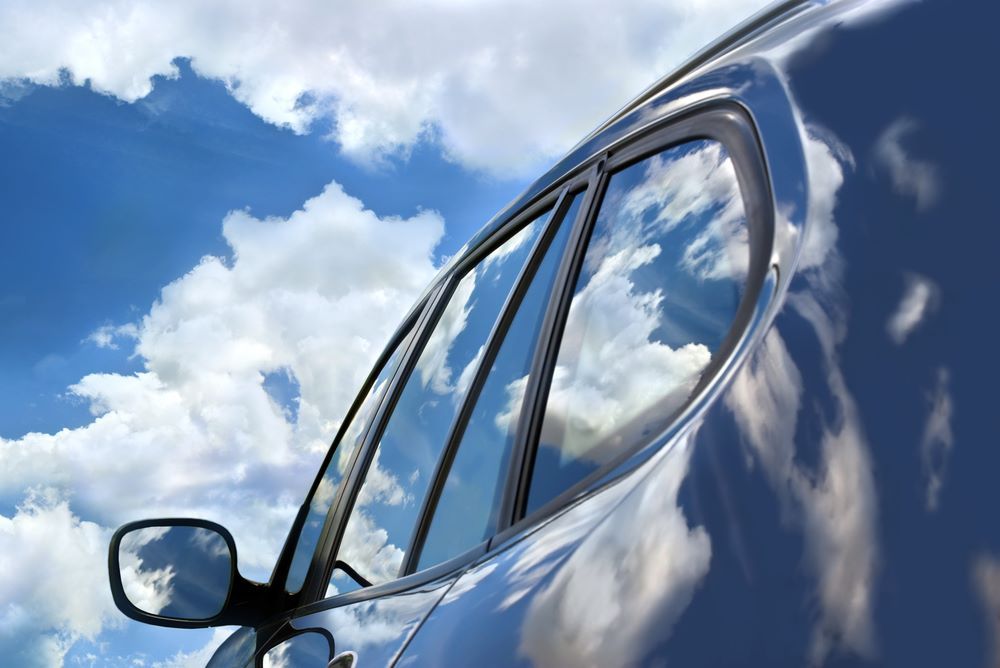 A Close Up of a Car Window With Clouds Reflected in It — Keppel Coast Windscreens in Coorooman, QLD