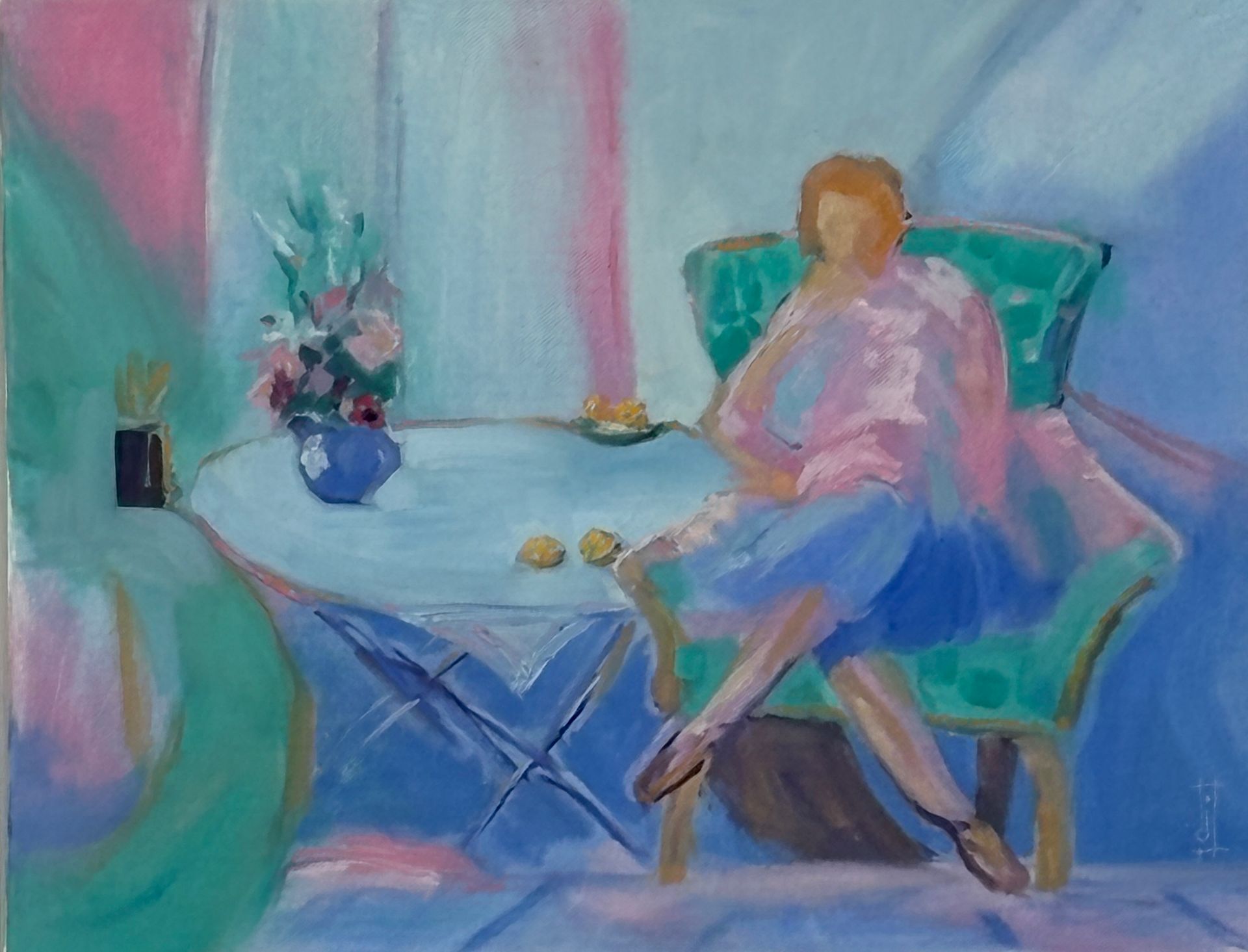 woman sitting in her arm chair in bright pinks and greens