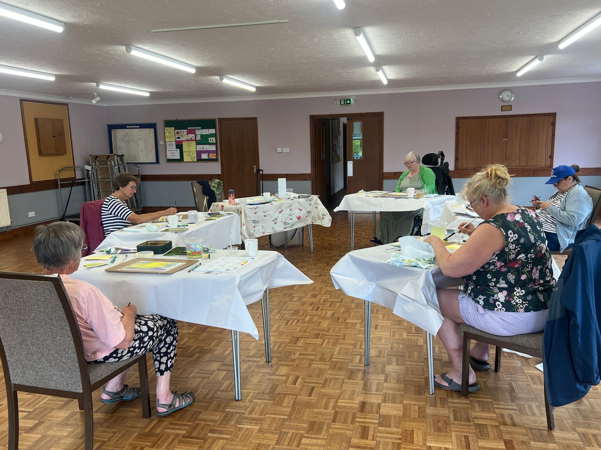A WI group painting woodlands in watercolour