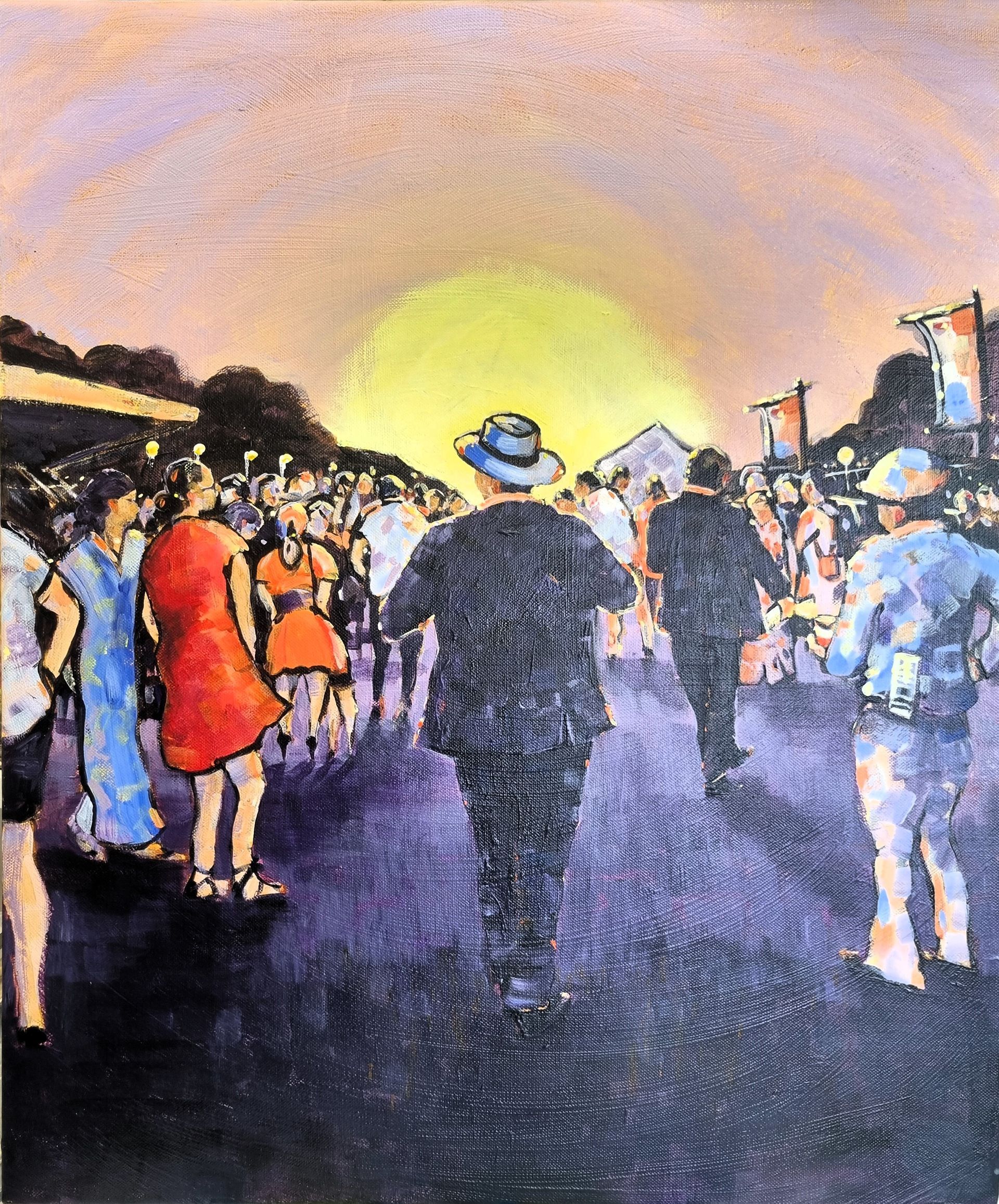 A view of a crowd at the races with a tall gentleman walking into the sunset.