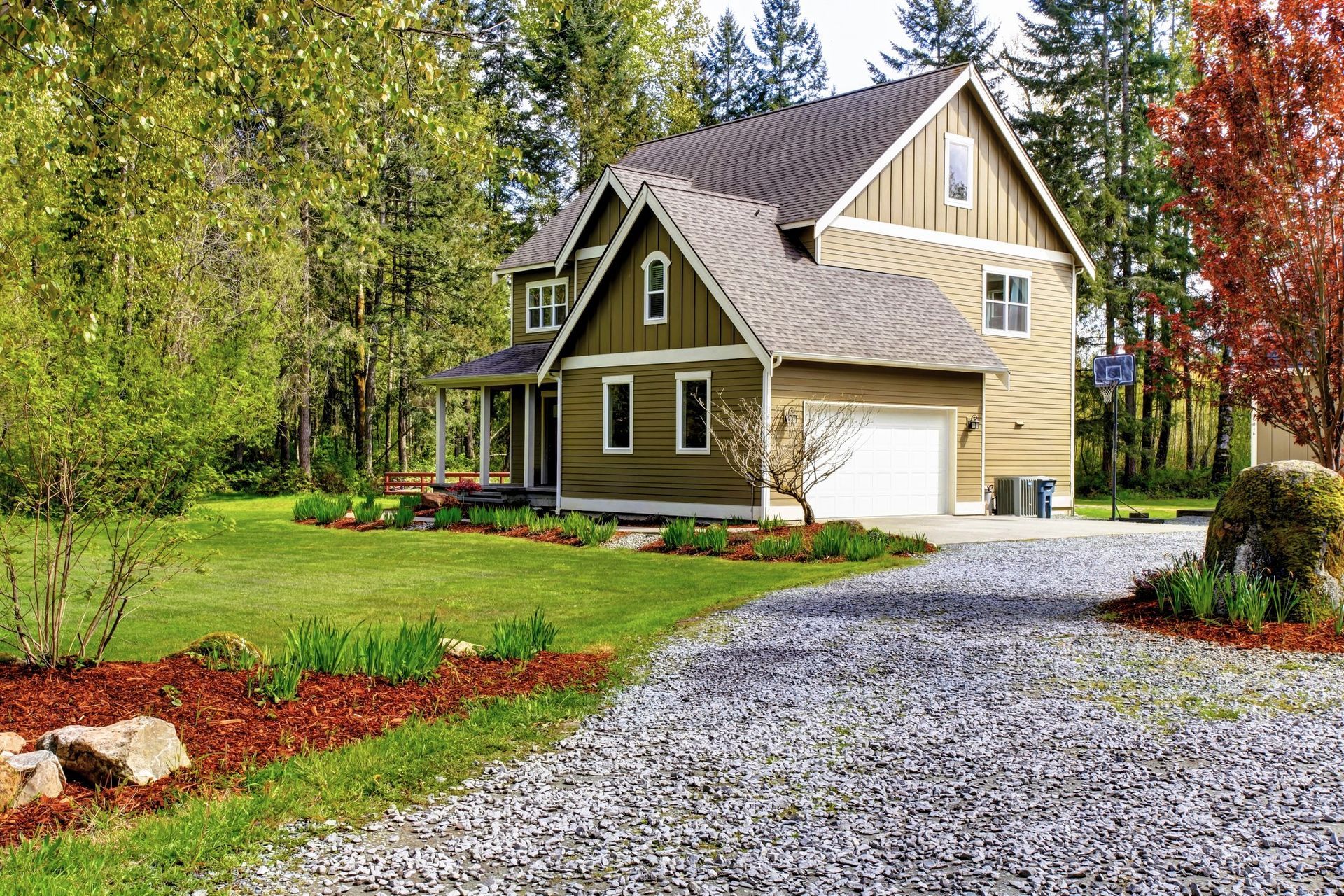 Country house exterior with entrance and gravel driveway.