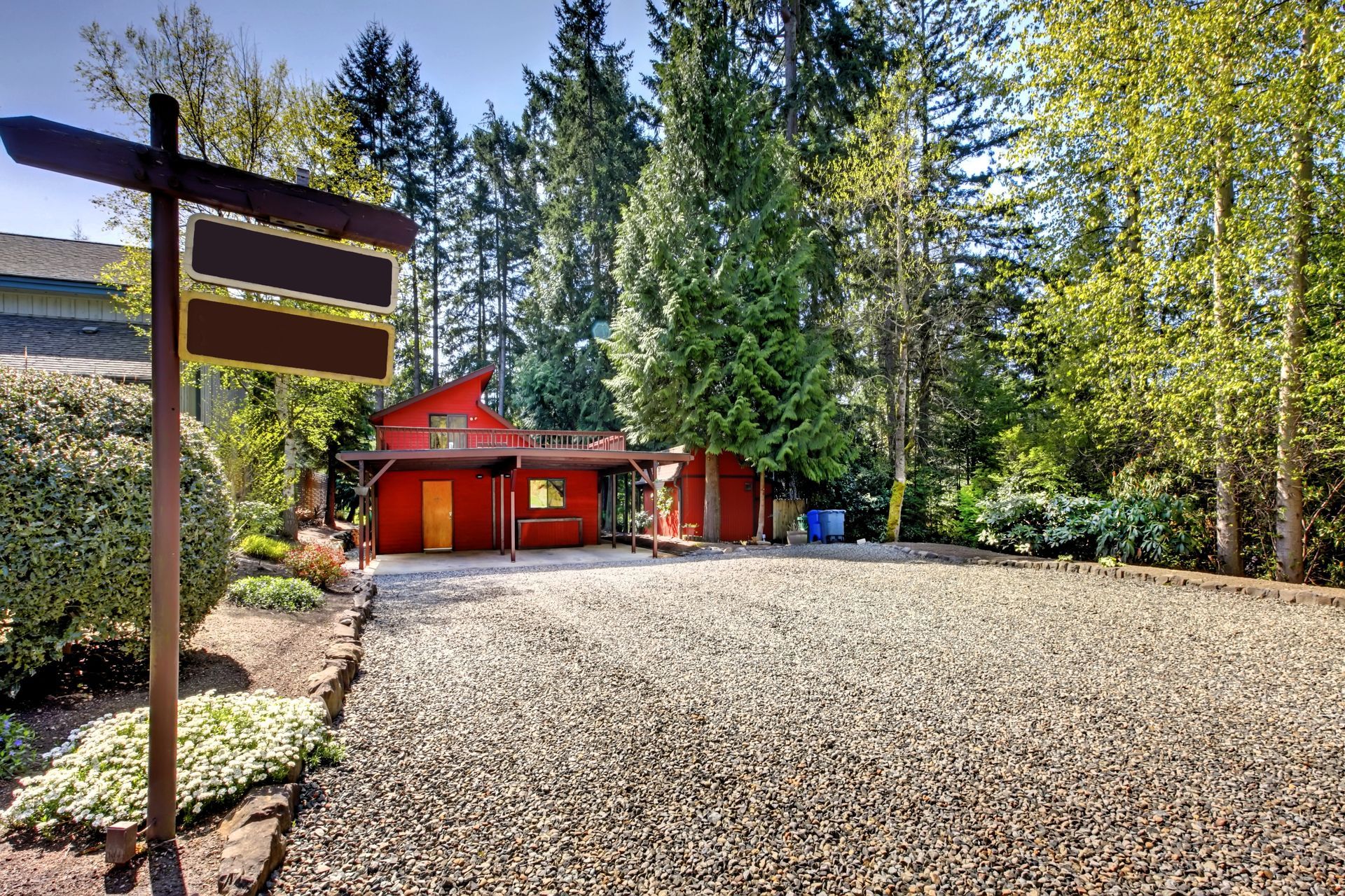 Countryside home with gravel driveway blending harmoniously into natural surroundings.