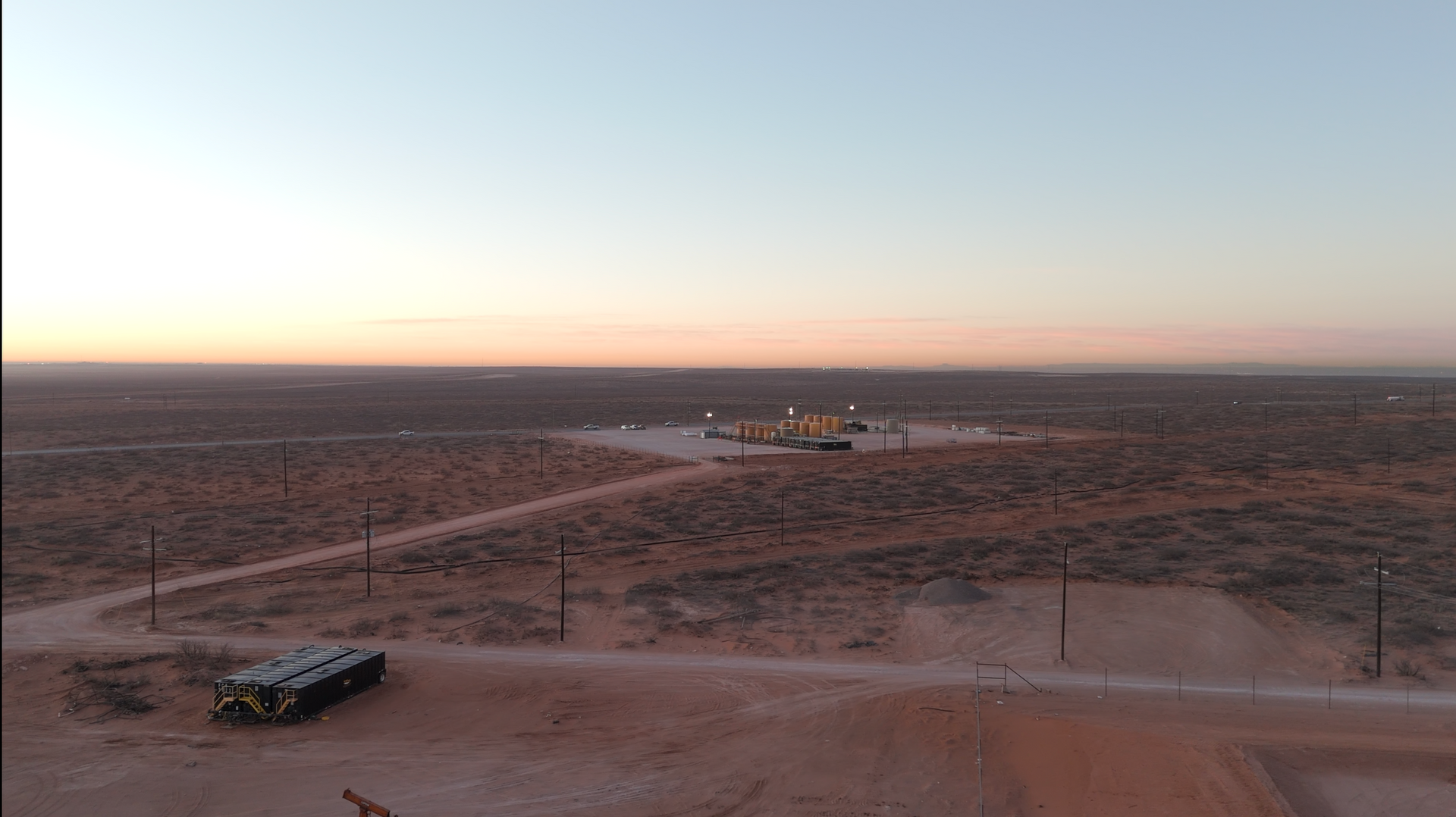 An aerial view of a desert landscape at sunset