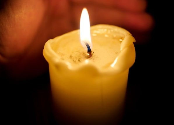 Close up of candle with soft glowing flame for Gilbert, AZ funeral homes.