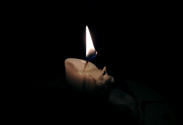 Glowing candle symbolizing compassionate cremation services in Gilbert, AZ.