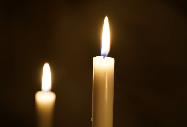 Two lit candles representing cremation services in Gilbert, AZ.