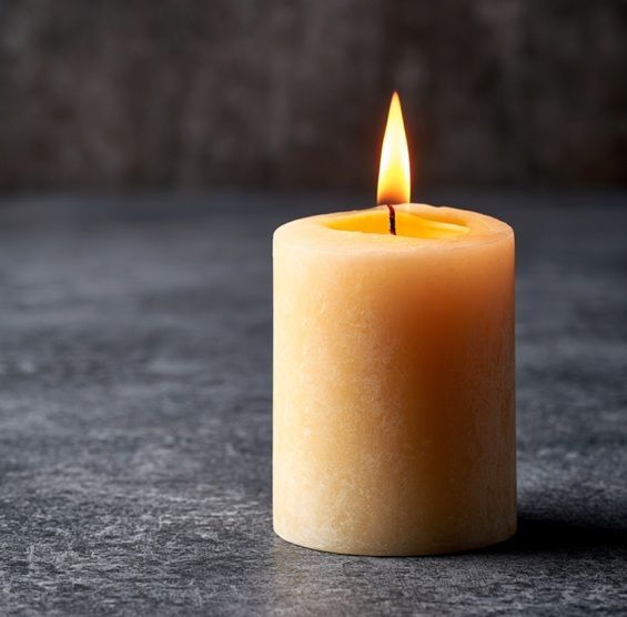 Lit memorial candle symbolizes cremation services in Mesa, AZ, honoring cherished memories.