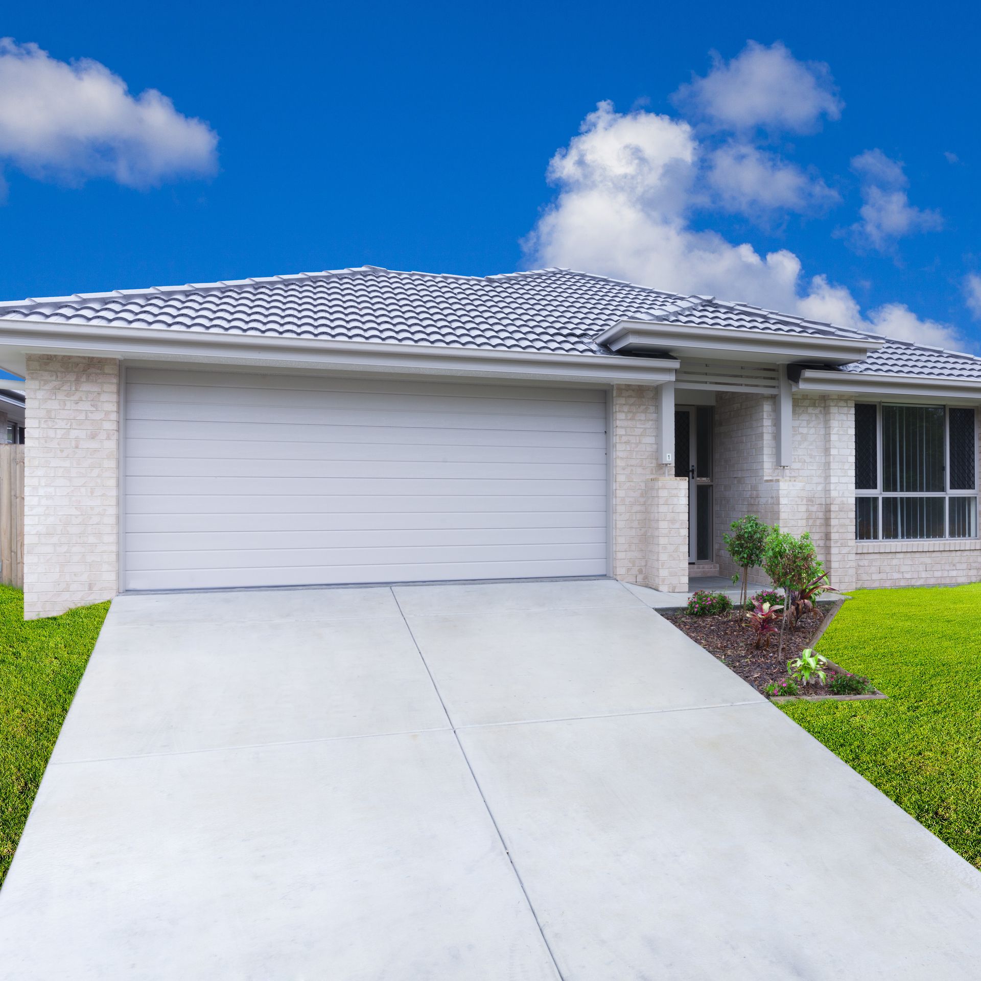 A suburban house with a wide garage with overhead door