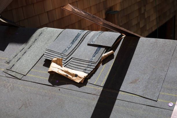 A roof with a hammer and a piece of paper on it