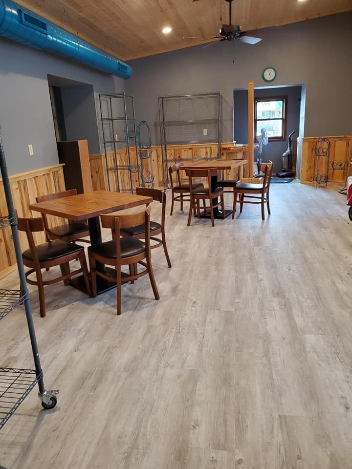 A large room with tables and chairs in it.