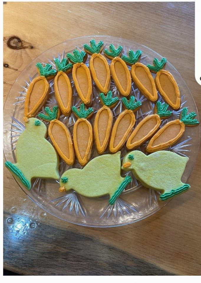 A plate of cookies decorated to look like carrots and ducks